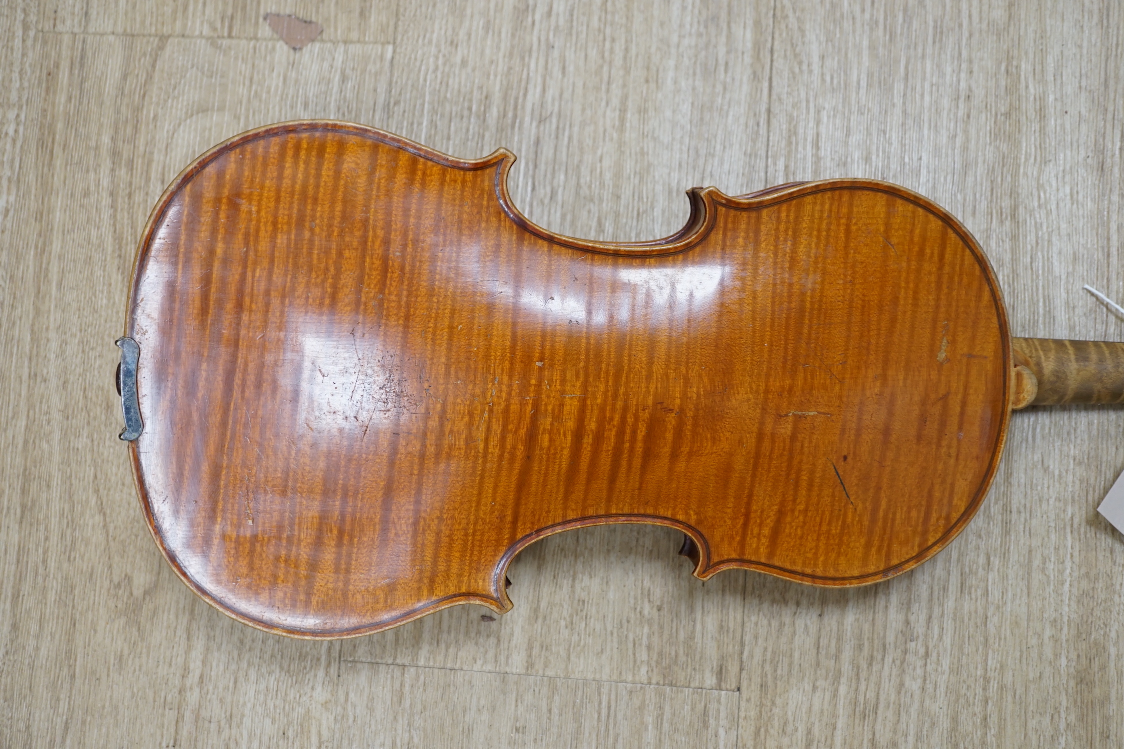 An uncased early 20th century violin, length of body 35.5cm